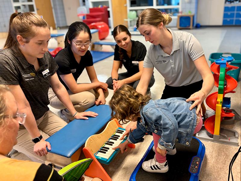 WSU Physical Therapy students work with pediatric patient at Heartspring