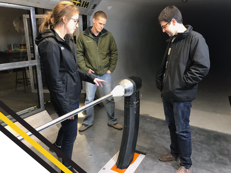 Hassan Farhoud and Mark Elliott are learning from classmate, Maggie Koops, in the Beech Windtunnel