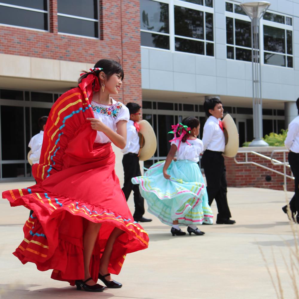 在拉丁传统月庆典上，孩子们随着传统歌曲起舞.